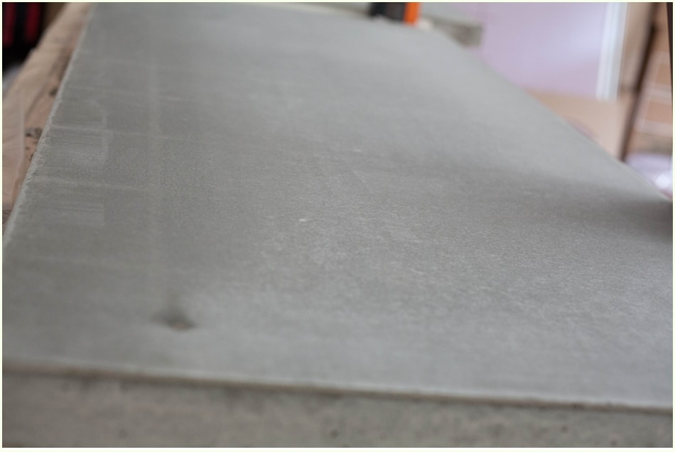 The smooth, gray surface of finished concrete countertops. 