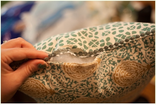 An open seam of a no-sew pillow lined with fabric glue.