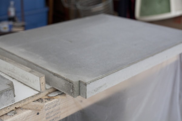 DIY concrete countertops sitting on top of molds for home kitchen renovation.