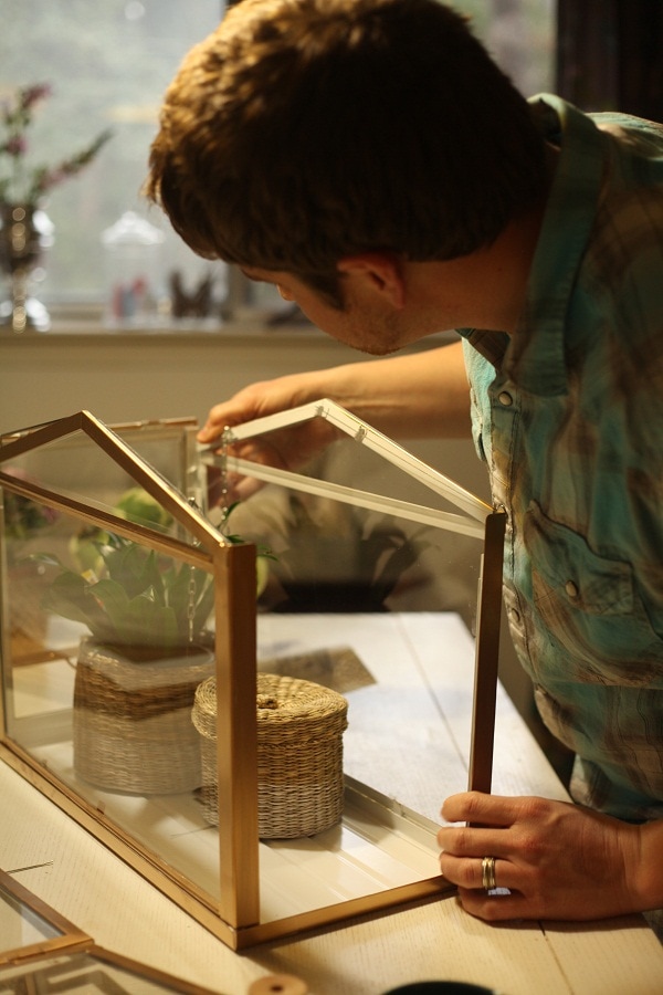 A man assembles the SOCKER Greenhouse from IKEA 