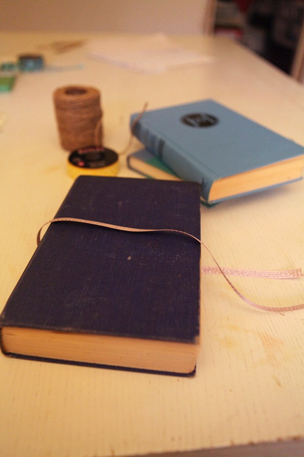 Ribbon being added onto handmade journal.