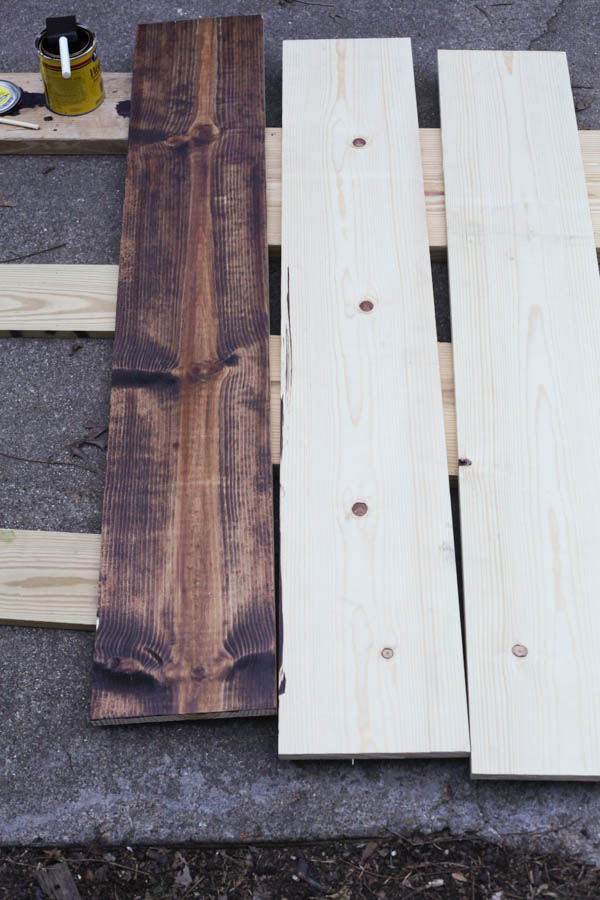 3 planks of wood, one stained with a honey colored wood stain. 