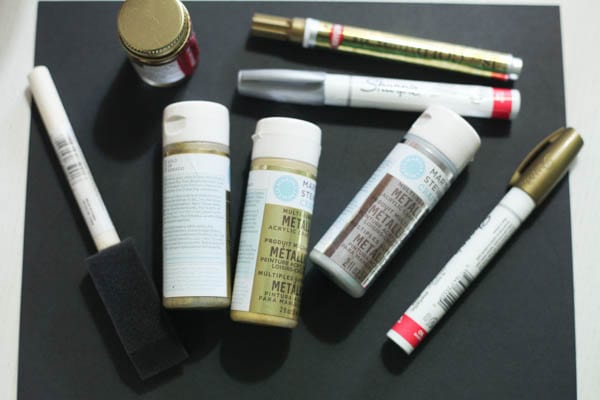 A collection of gold paints and pens to decorate herb pots. 
