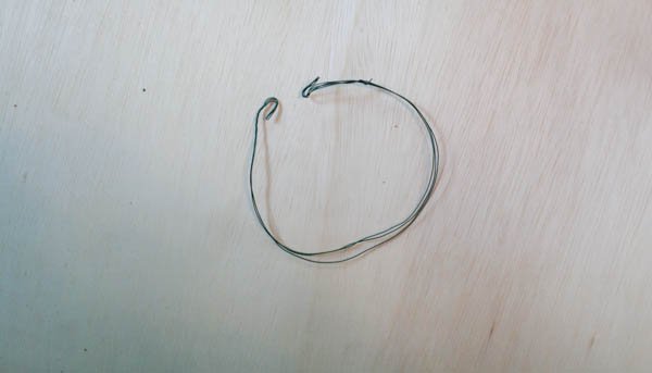Small wire circle on a wooden surface. 