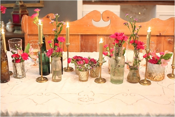 I love this table decor! I really like the idea of having multiple little containers of flowers spread out rather than one big one. I'm going to be keeping an eye out for cool bottles to use like this too! Super cute for Valentine's Day or any other day really! 