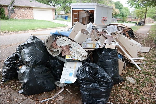 A pile of trash on the curb. First home staging step is to declutter