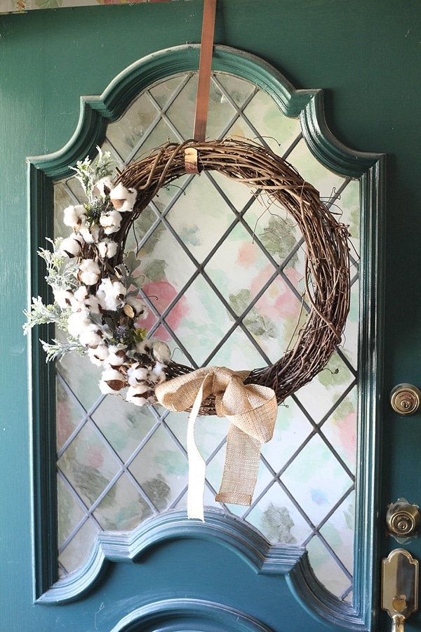 A DIY fall wreath hanging on the front door 