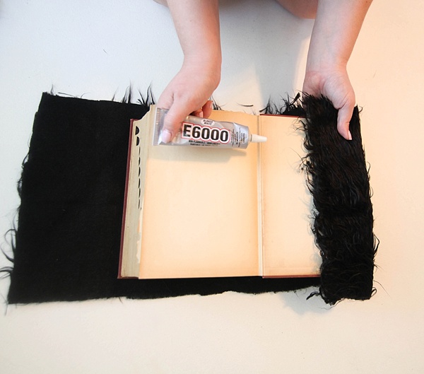 Gluing faux fur to an old hardcover book. 