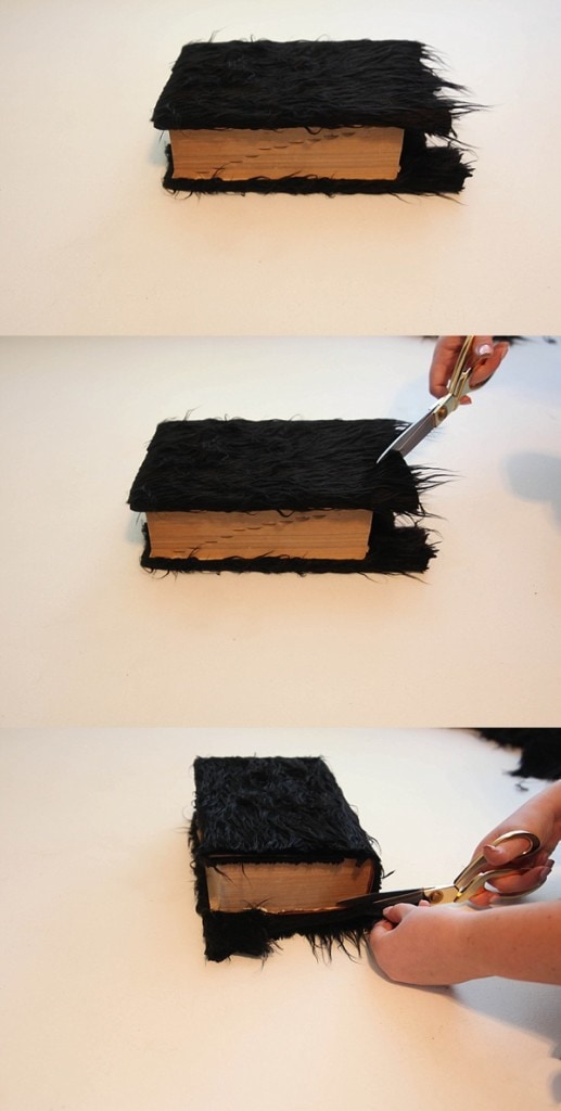 Trimming faux fur off an old book cover.