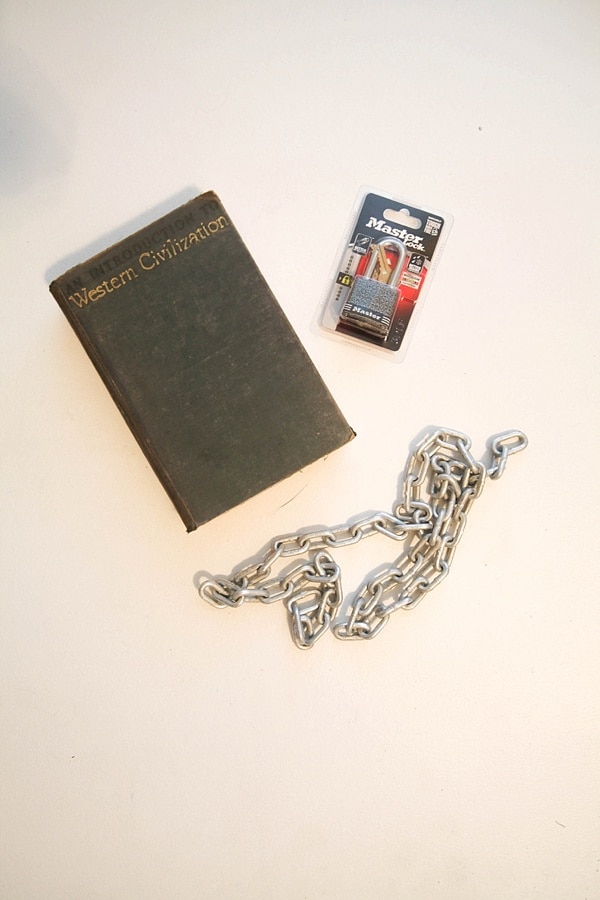 An old book, a metal chain, and a padlock 