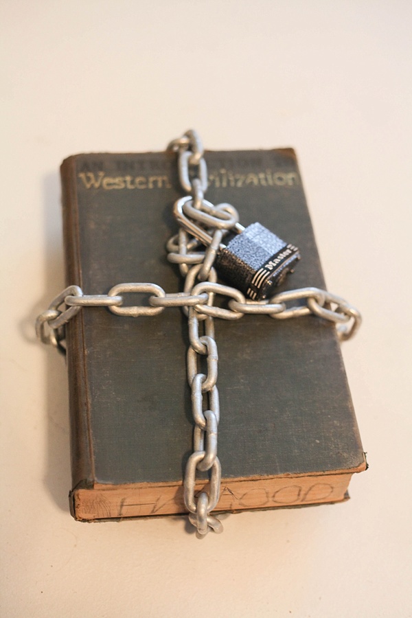 A book with a chain wrapped around it and a lock on the chain