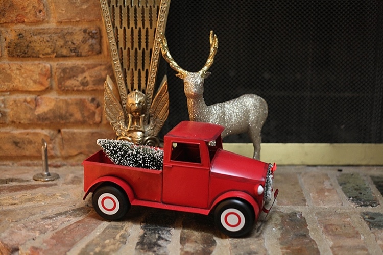 antique red truck with Christmas tree in the bed