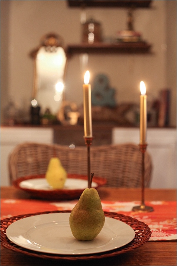 table setting with a pear on the plate
