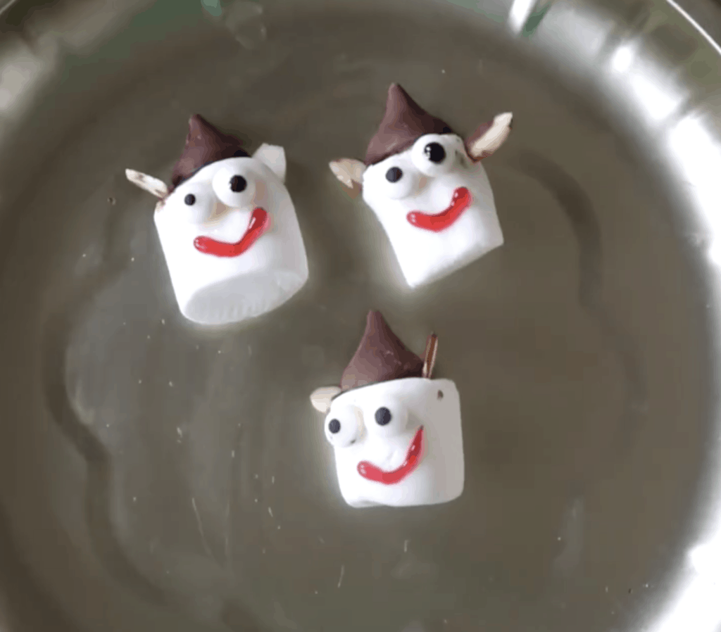 Marshmallows turned into christmas elves with chocolate kiss hat, and almond ears. 