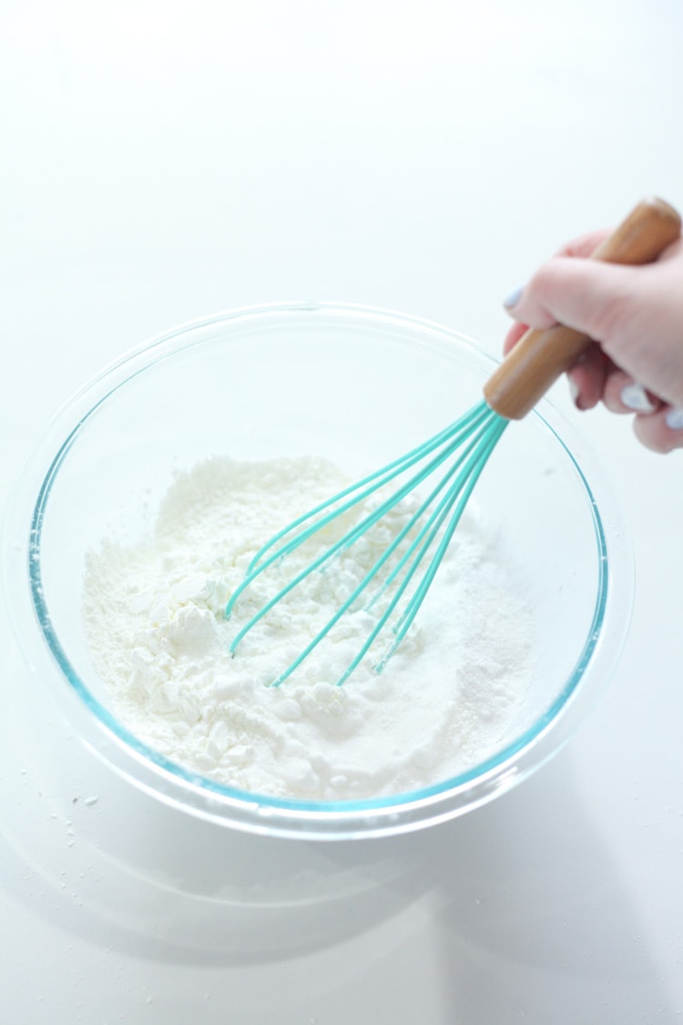 Mint whisk stirring dry ingredients for the lush bath bomb recipe