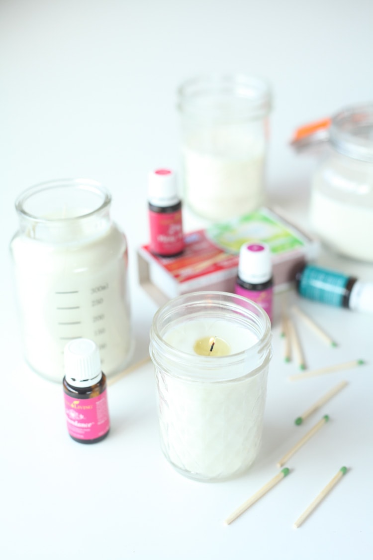 How to make candles - matches, candles, essential oil bottles all on table.