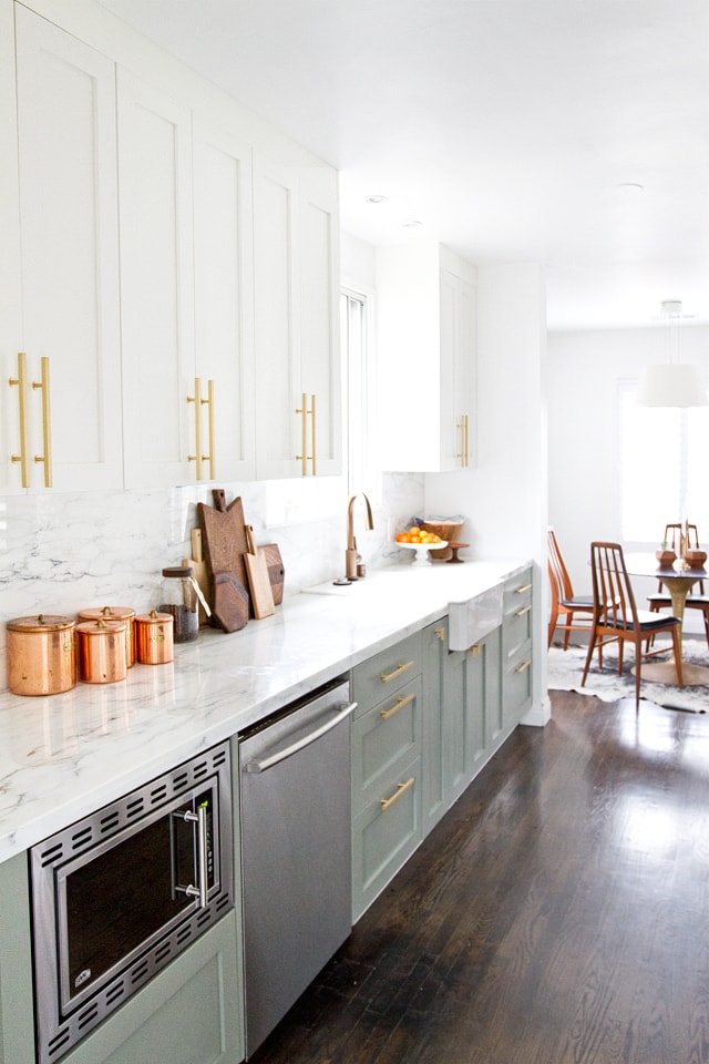 Obsessed with this kitchen and the gorgeous marble countertops! Love the mint cabinet color too.