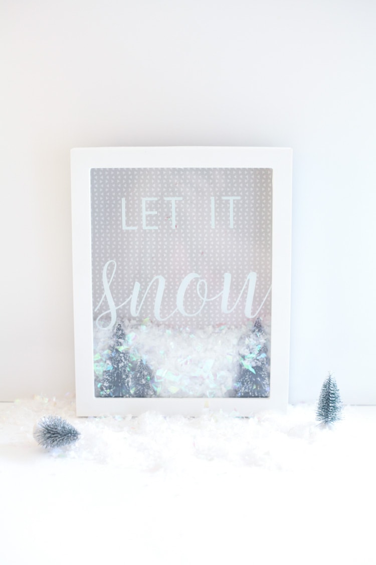 Let it snow! This DIY Christmas shadow box idea is an easy Cricut project for beginners. Super cute! #cricutdiy #christmasdiy #shadowbox #christmasshadowbox