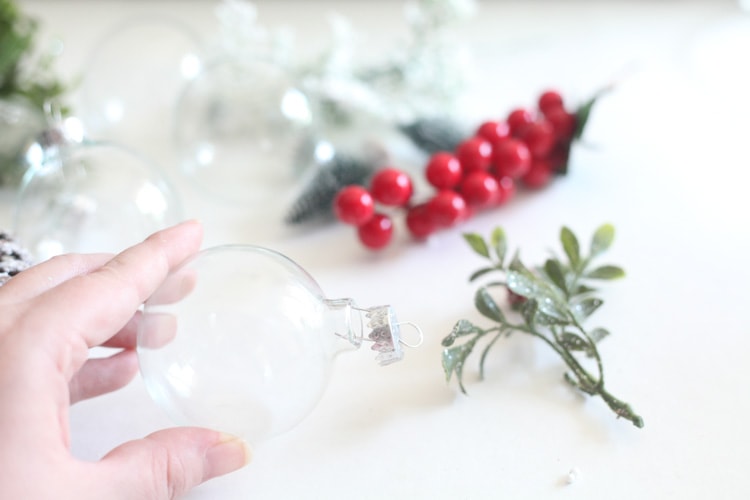 This easy diy christmas ornaments take a minute or less to put together! I've been searching for a new way to use clear glass ornaments...love this rustic idea!