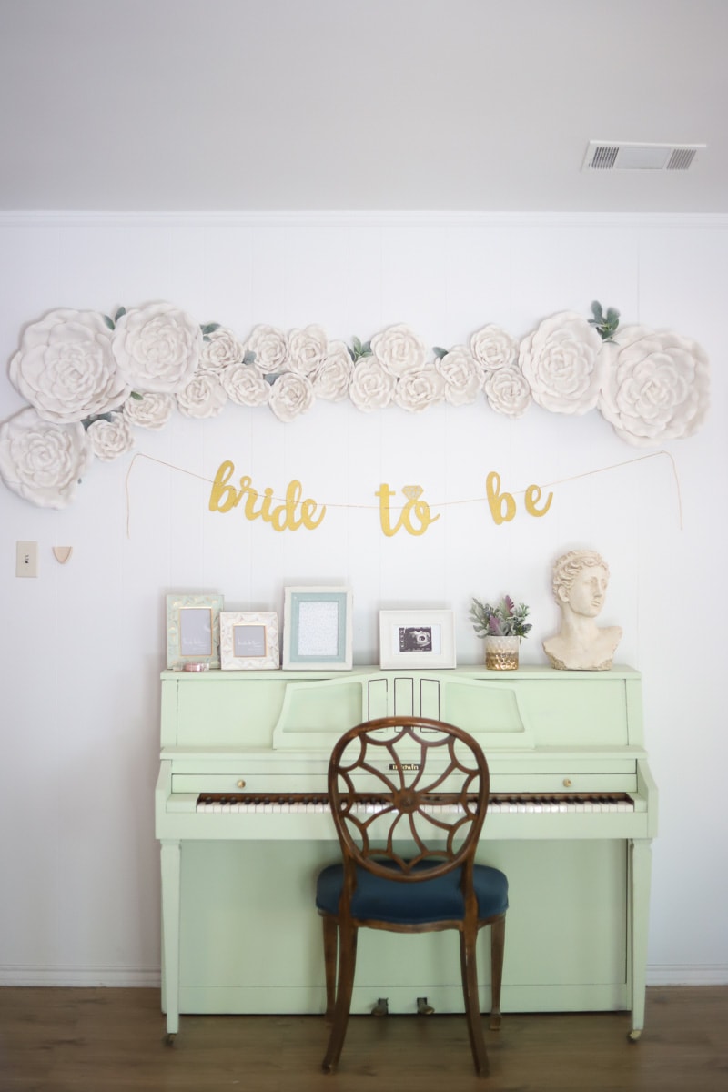 One of the living room wall decor ideas...DIY flower wall with a bridal shower banner underneath
