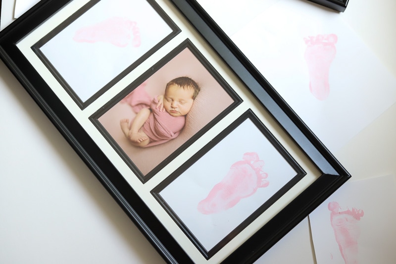 picture frame with baby foot prints and newborn photo