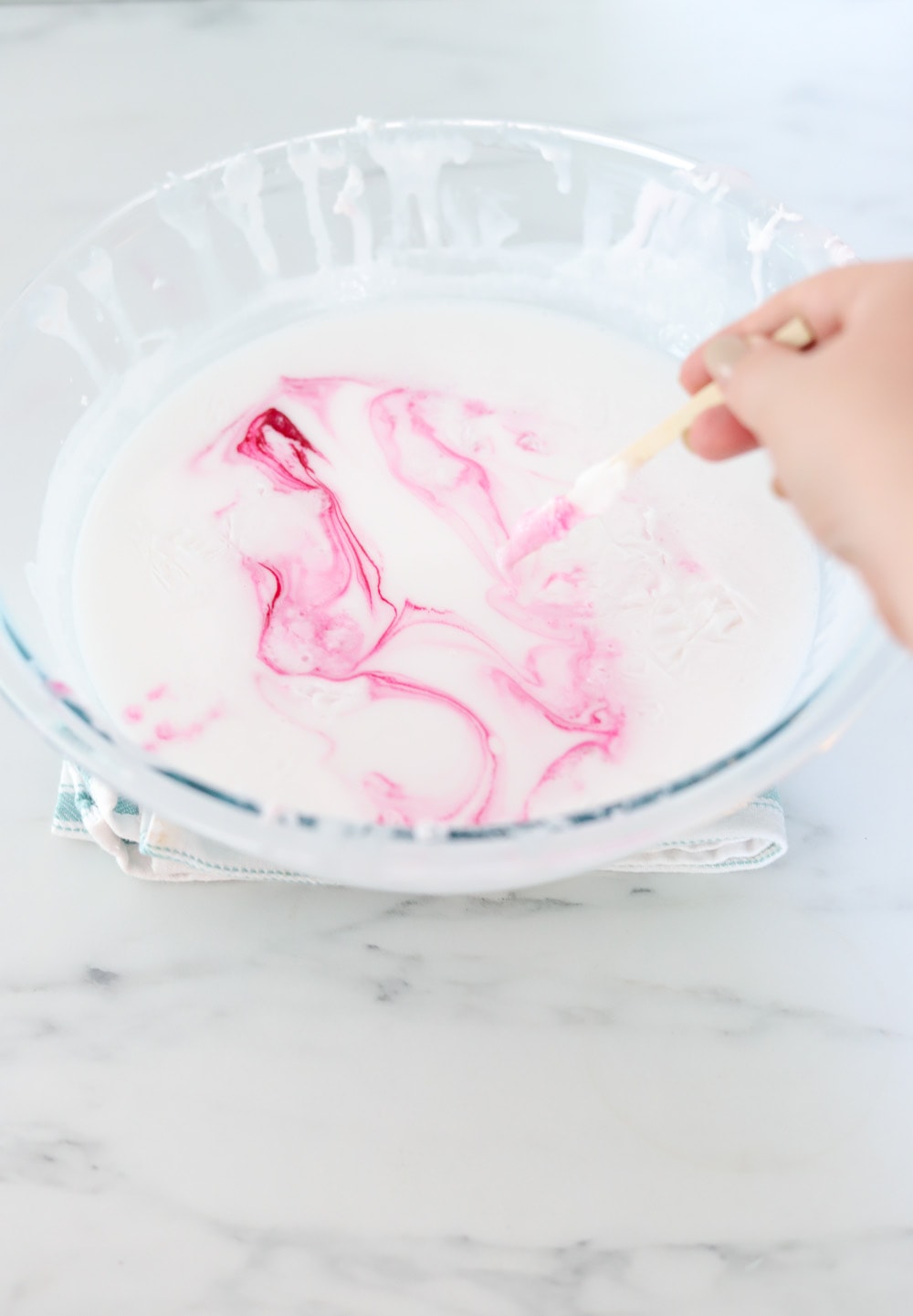 glass bowl full of melted soap with pink color