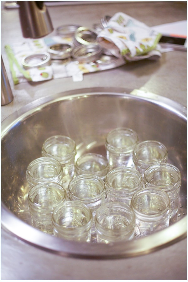 A sink filled with small mason jars.