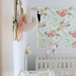 DIY nursery wall decor with flowers and a swan in a baby girl nursery with floral wallpaper in background