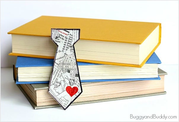 a tie shaped bookmark laid on some books