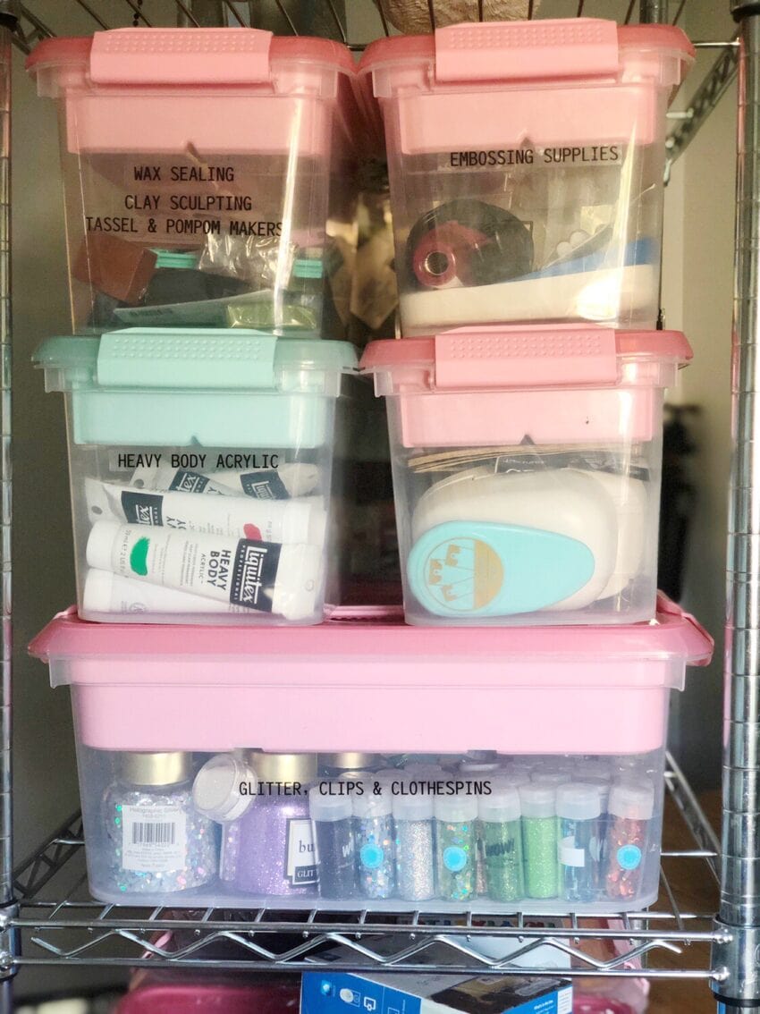 Organized bins in craft room filled with craft supplies.