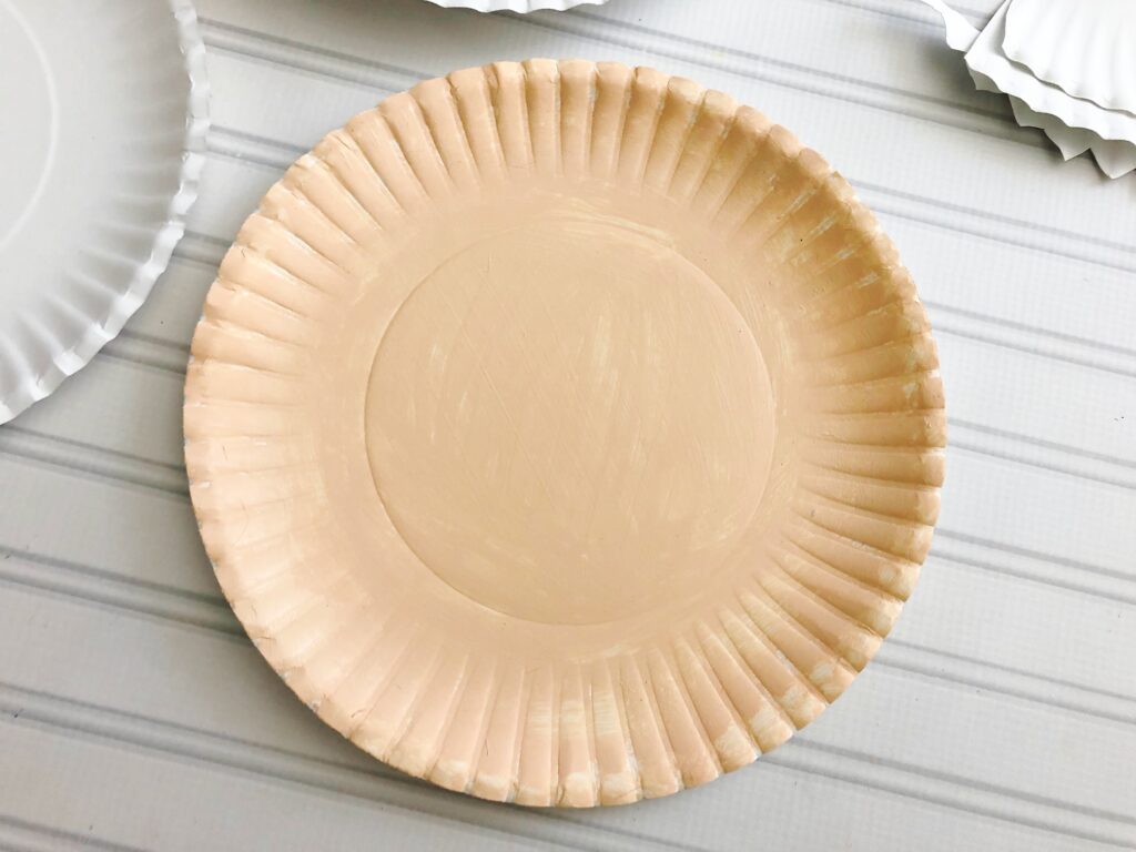 Paper plate painted a skin-colored tan.
