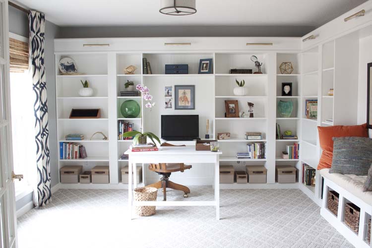 white bookcase in a home office with gray walls 