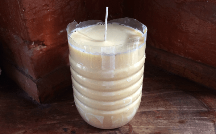 homemade talo candle in a plastic container