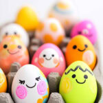 neon eggs with cute faces drawn on