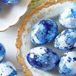 DIY marbled blue eggs on a white and gold plate
