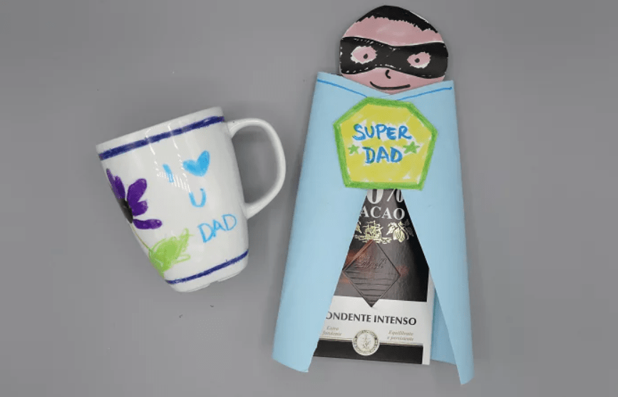 A painted coffee cup and chocolate bar wrapper that looks like a super hero - DIY Father's Day Gifts