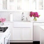 white dishwasher and oven in a bright white kitchen space