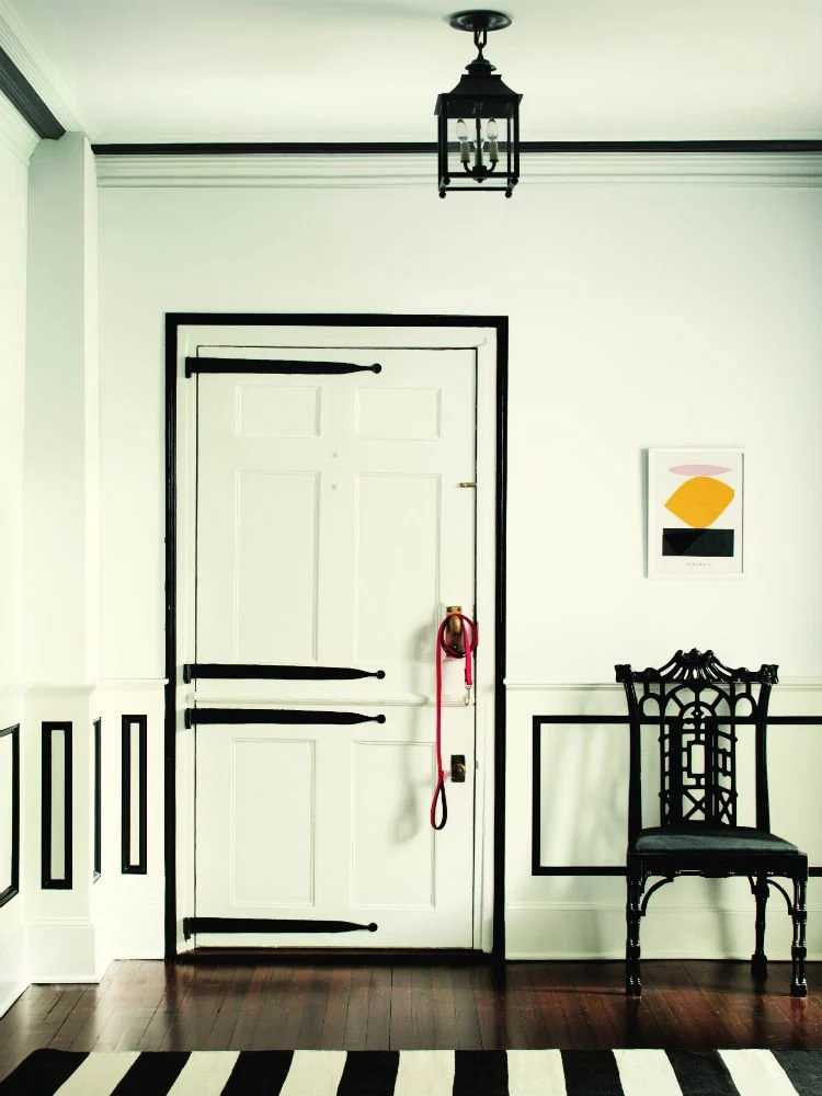 Entryway door with wainscotting and trim color Black Satin by Benjamin Moore.