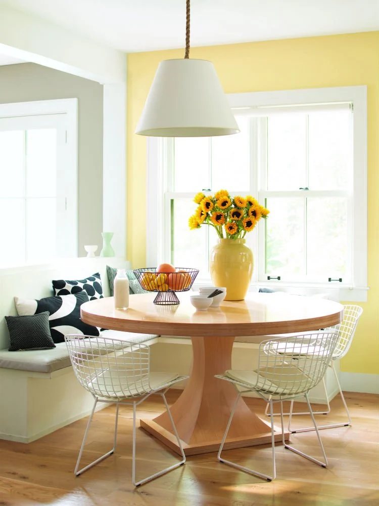 Sunny dining room with yellow walls and trim color Chantilly Lace by Benjamin Moore.