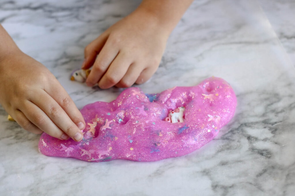 Add small toys to unicorn slime to make it more fun!