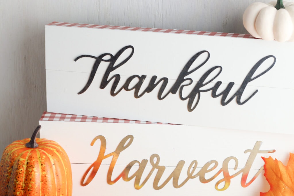 DIY Metal Word Signs made with Dollar Tree inspirational wall words. DIY fall decor paired with decorative pumpkins and faux leaves. 