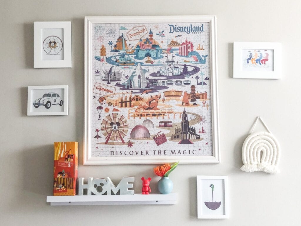 Disney puzzle framed in a white frame hanging on a white wall. 