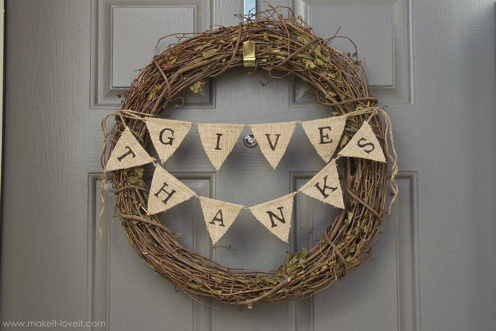 simple grapevine form with mini pennant banner with Give Thanks stenciled on for a Thanksgiving wreath