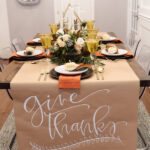 Thanksgiving table set with butcher paper with the words Give Thanks written on it.