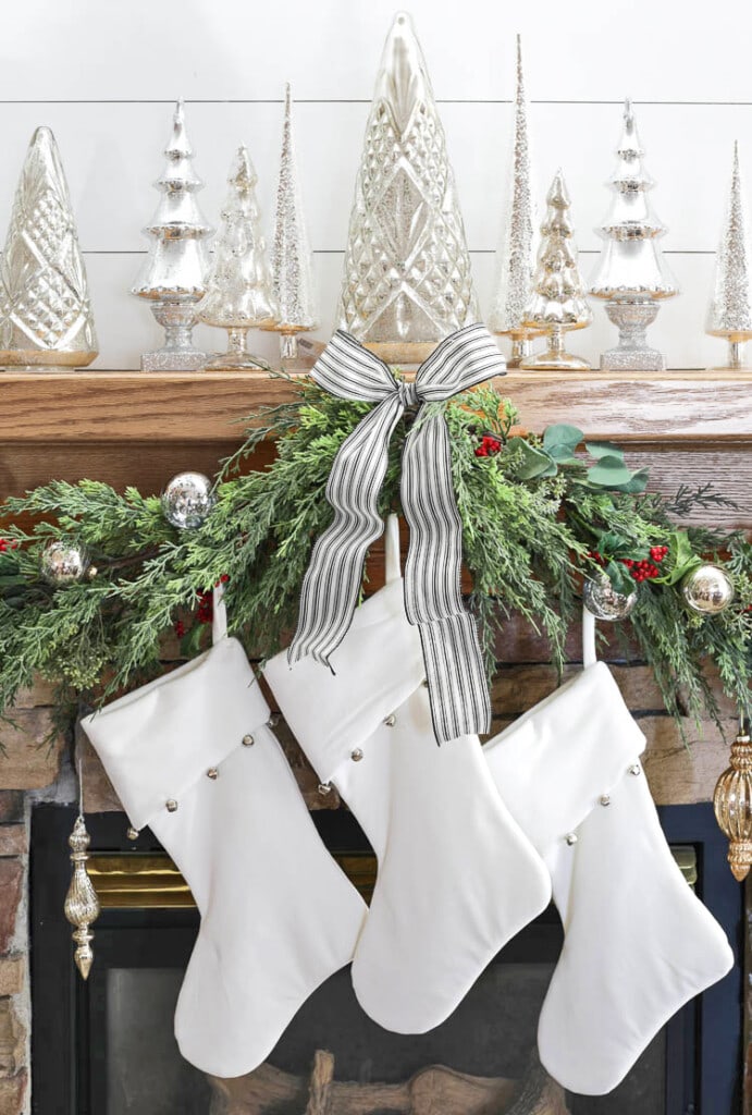 garland, ribbon, and stockings Christmas mantel decor