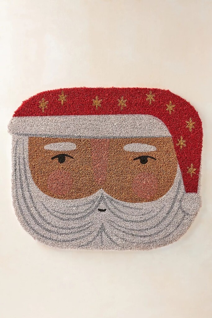 a door mat in the shape and image of santa's face