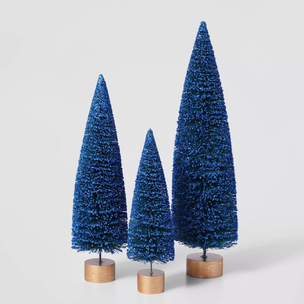 three blue jewel toned bottle brush Christmas trees for decor
