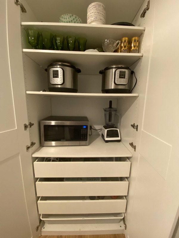 appliances and glassware in a kitchen cabinet