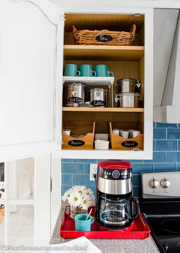 baskets, canisters and mugs in a coffee themed kitchen cabinet