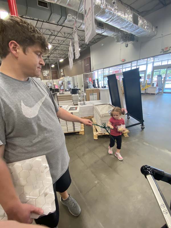 Man and little girl in a home improvement store.